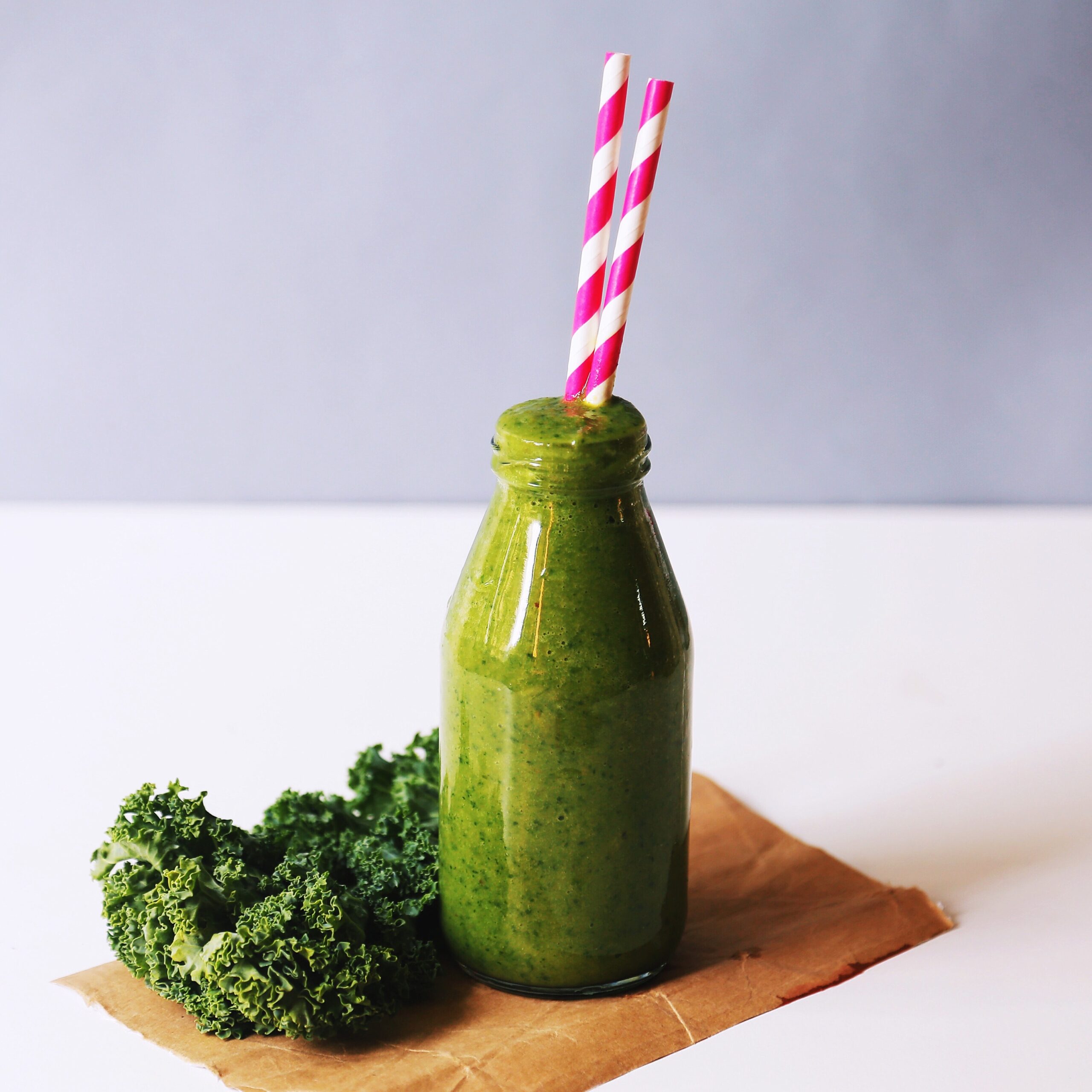 Green Juice with Pink and White Paper Straw