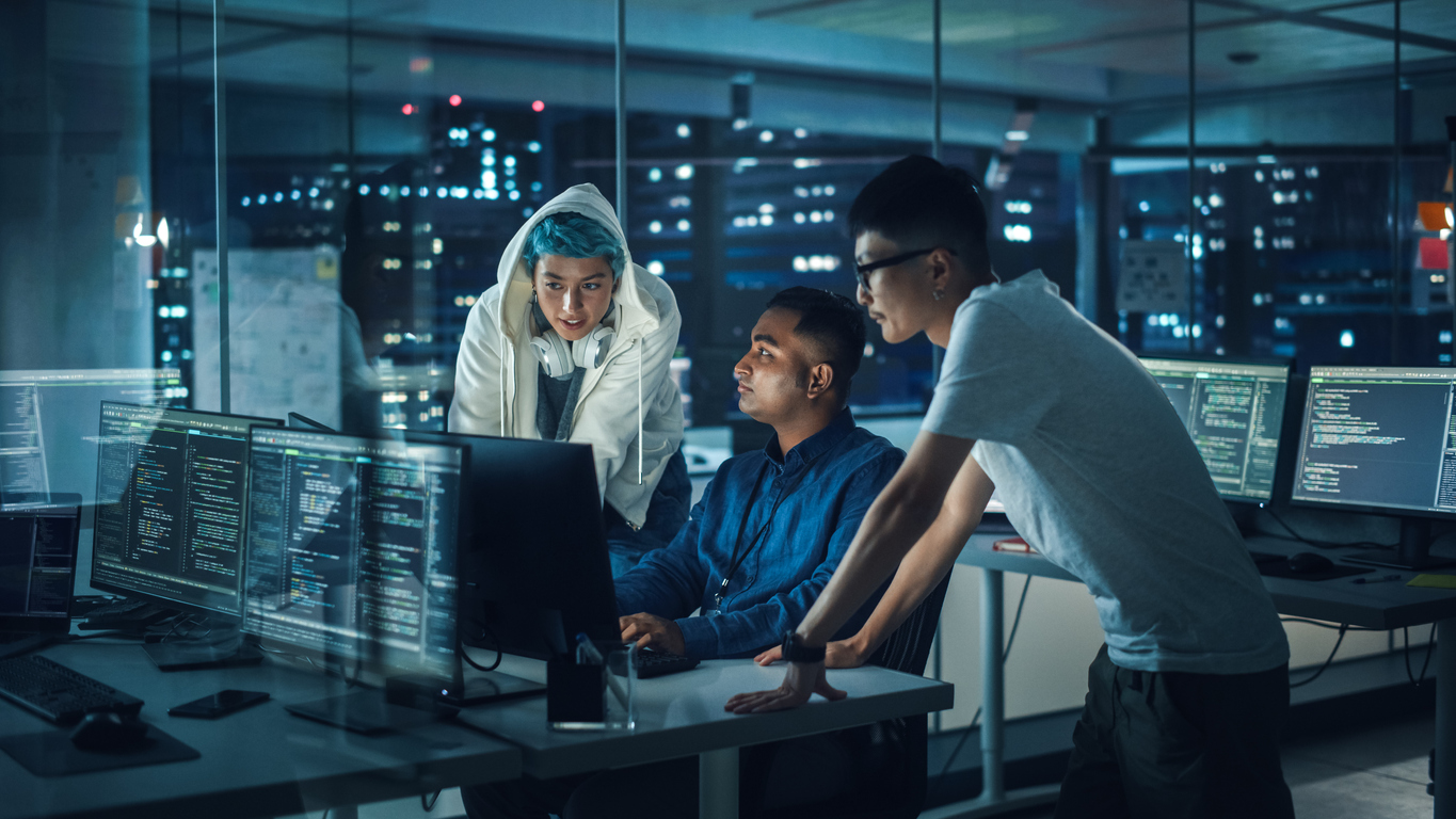 Shot of Employees Working in an Office at Night
