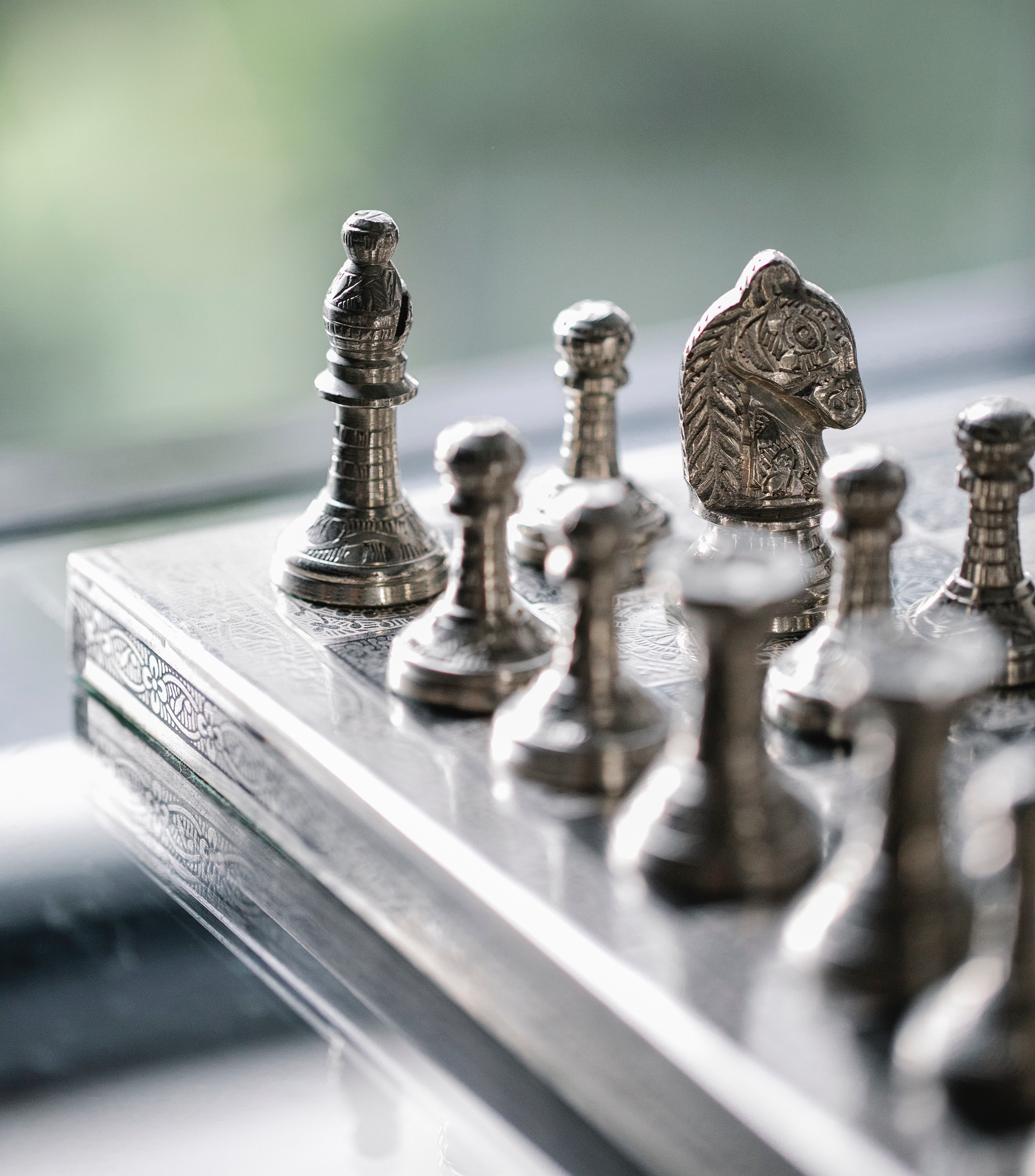 Steel Chess Pieces on chess Board