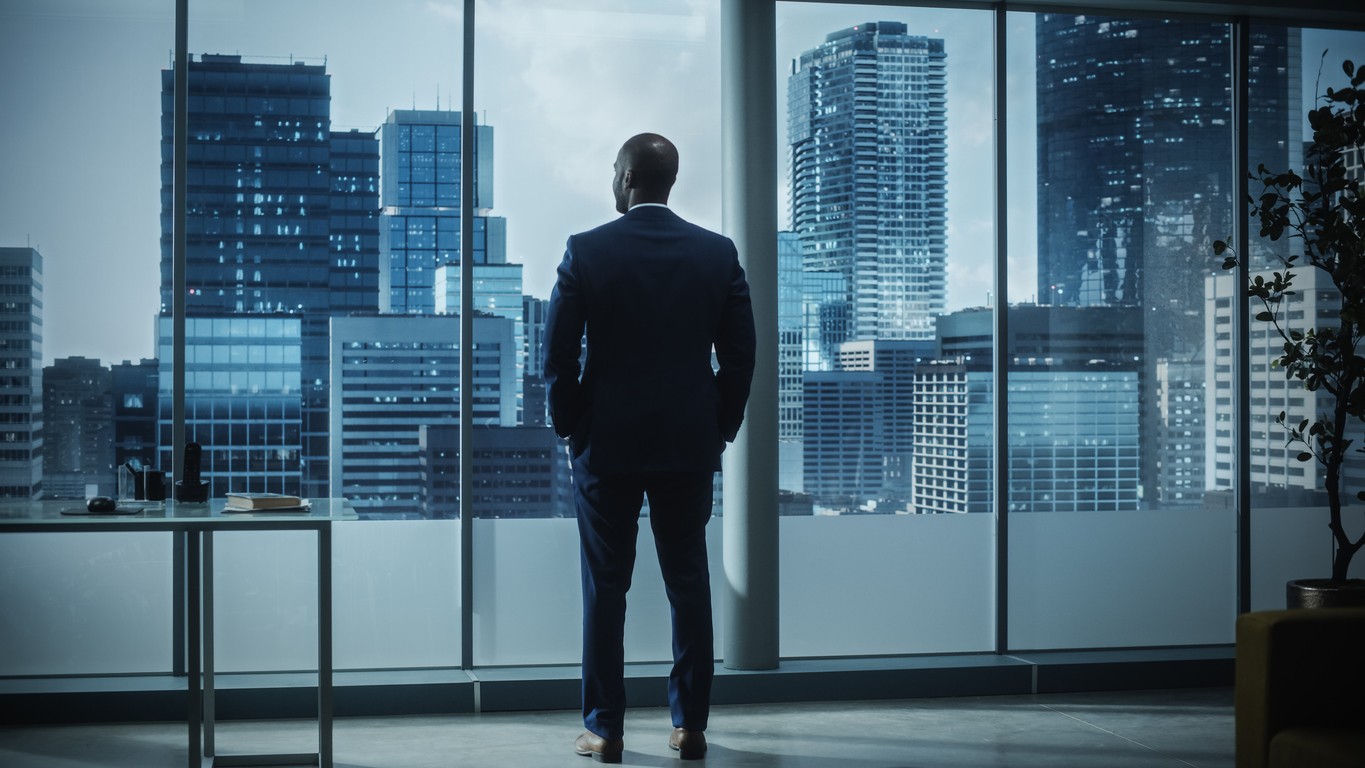 African-American Businessman Looking Out Office Window