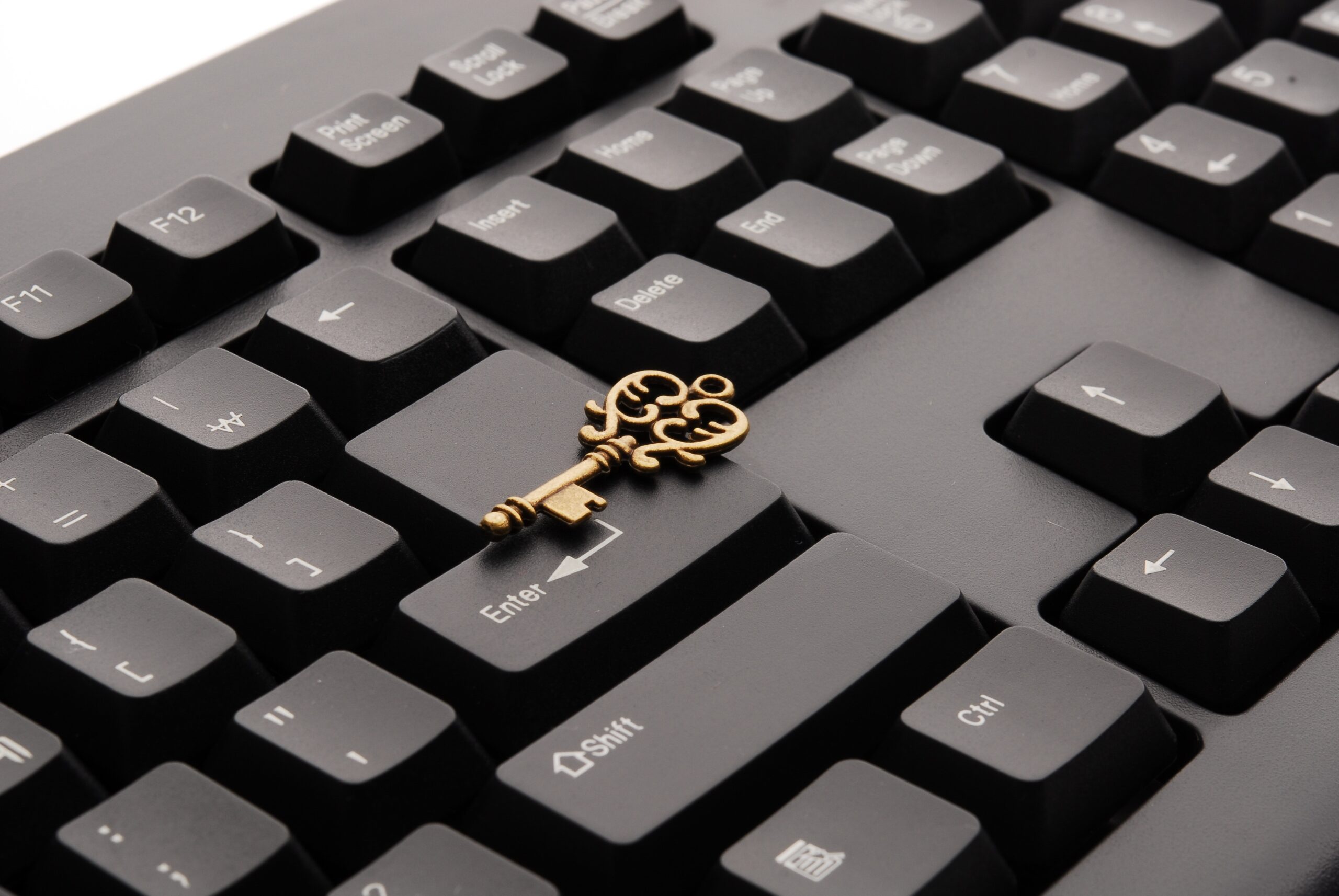 Close Up image of keyboard with a golden key on it