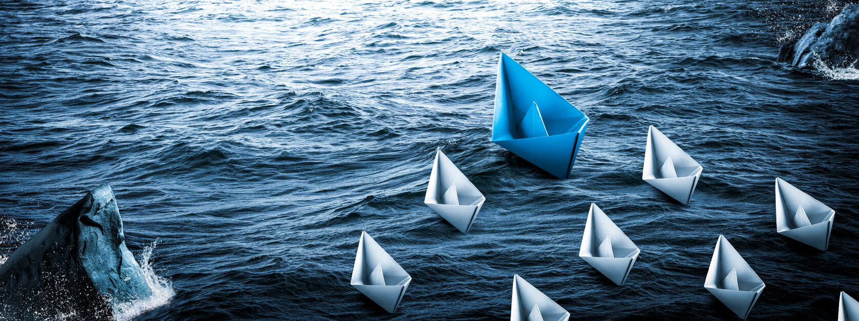 Blue Paper Boat Leading A Fleet Of Small White Boats