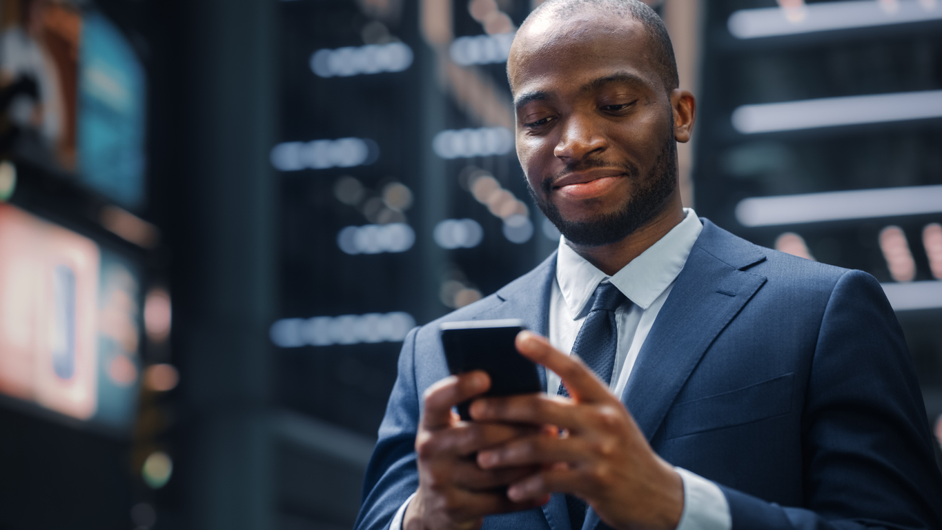 African-American businessman smiling at his phone