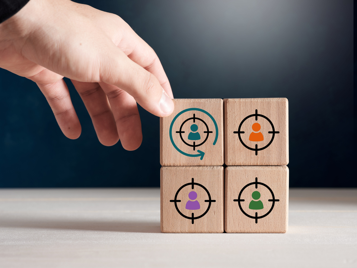 four wooden cubes with retargeting marketing icons on each