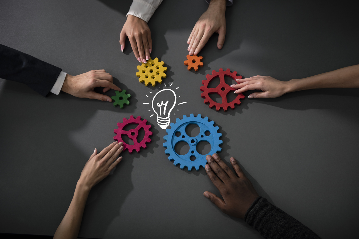 business team connecting gears together, symbolizing teamwork and ideas concept