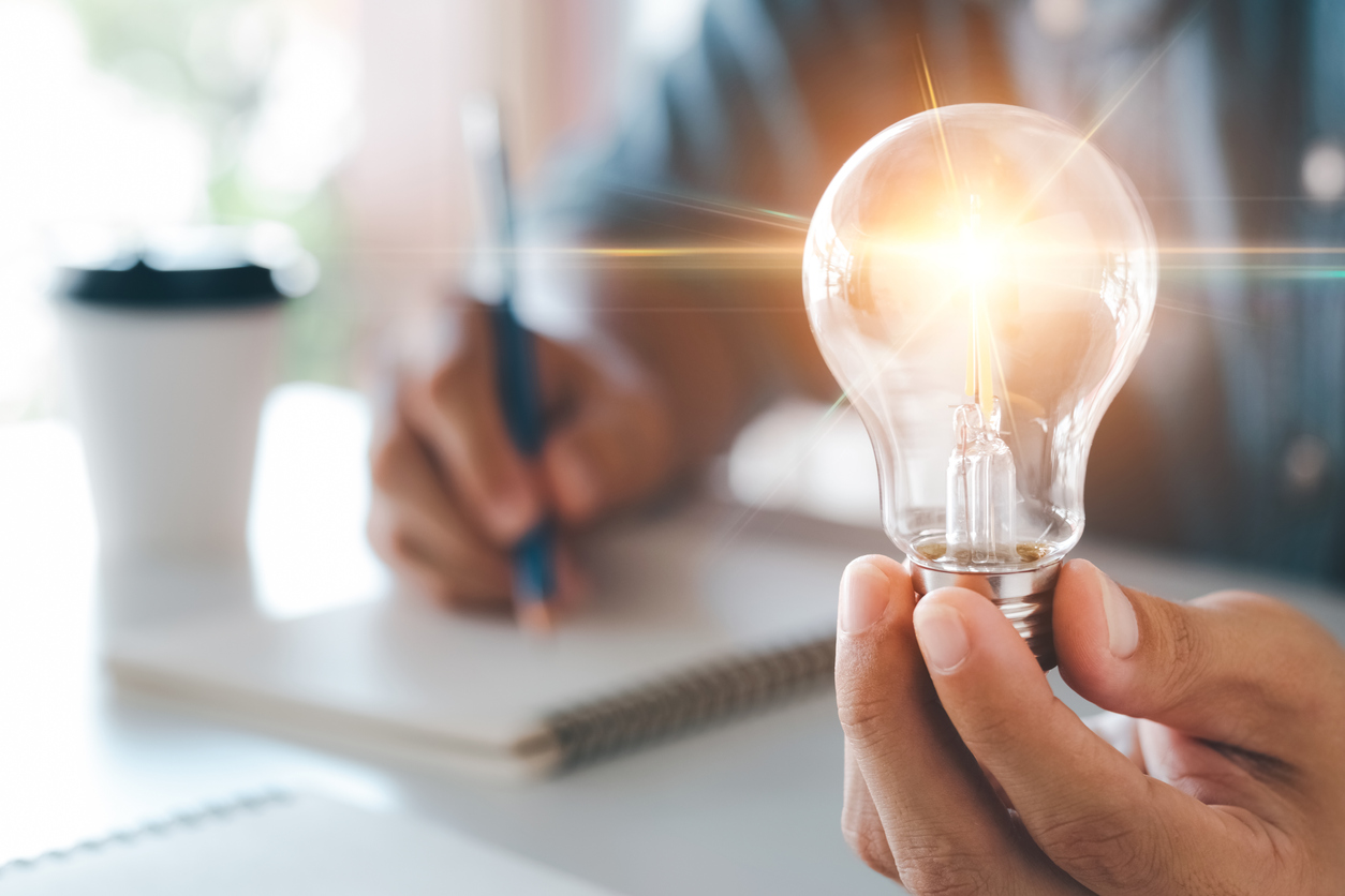 business person holding a lightbulb, business intelligence concept